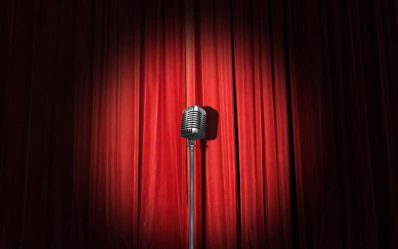 Microphone in front of a theatrical velvet curtain