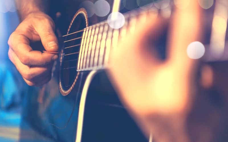 Close up of a man playing guitar