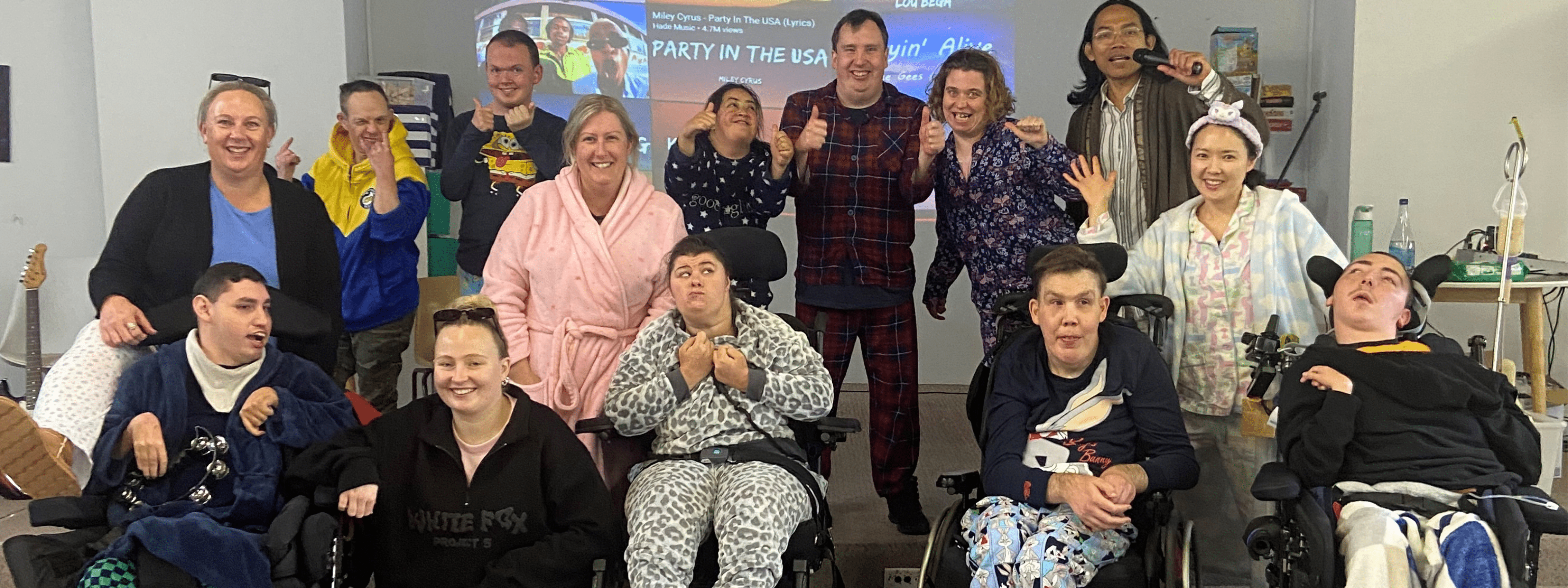 Coastlinkers and staff pose together in pyjamas